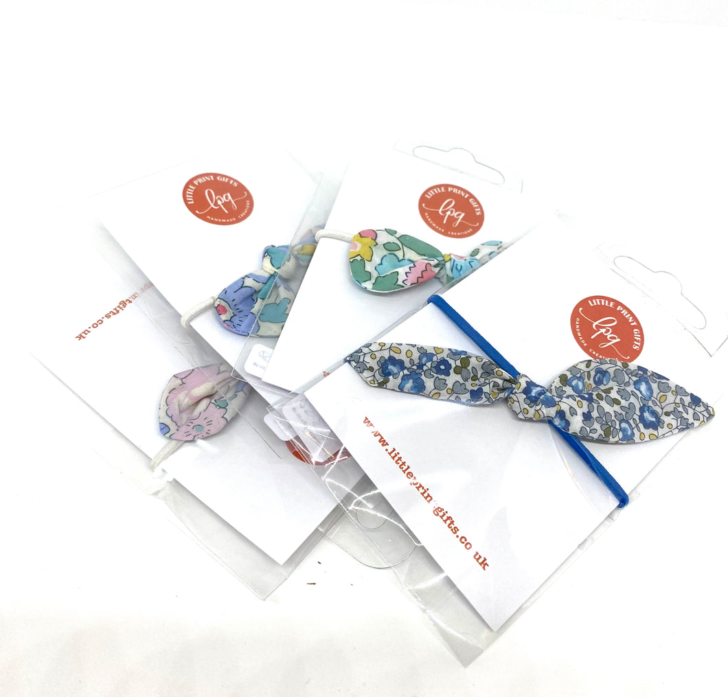 Set of four small Liberty fabric tie bows on elastics